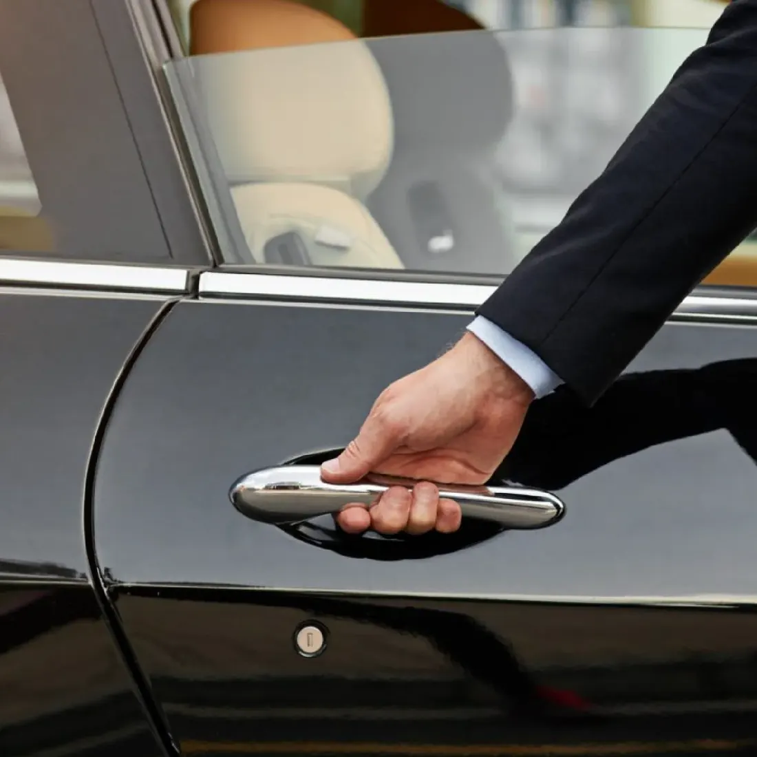 Chauffeur opening a car door