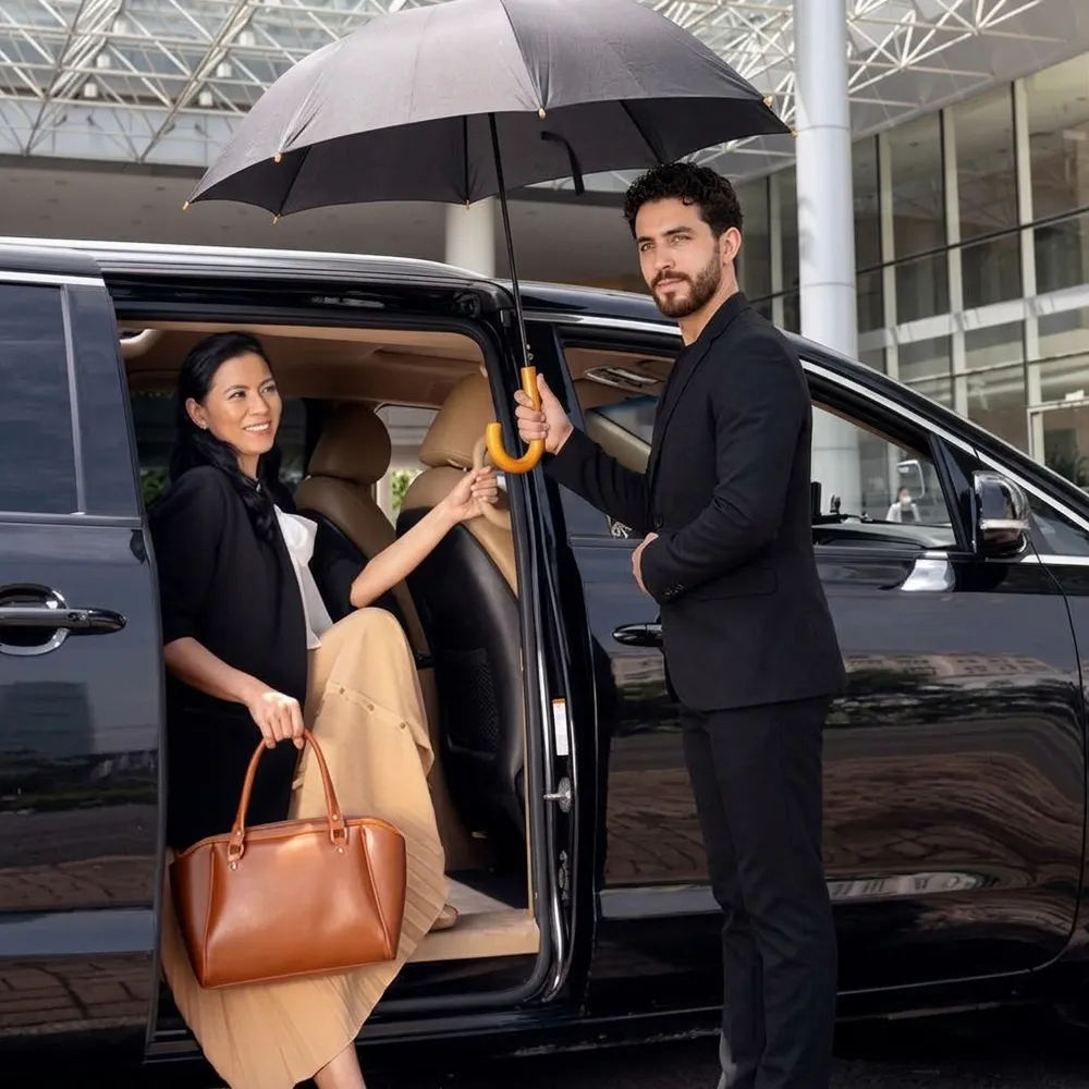 Driver opening the car door for a traveller