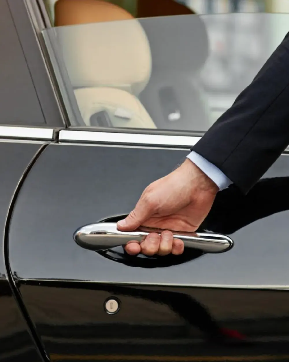 Chauffeur opening a car door